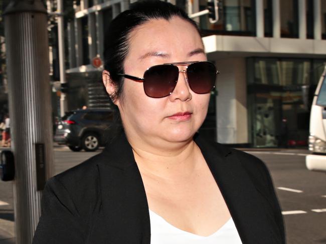 SYDNEY, AUSTRALIA- News Wire photos APRIL 27 2021- Jie Shao (second from left) leaving Sydney Downing Centre court flanked by her legal team. Trial of Chinese doctor charged with manslaughter after Jean Huang, 35, died from a botched breast implant administered in Chippendale in 2017. Picture: NCA News Wire / Adam Yip