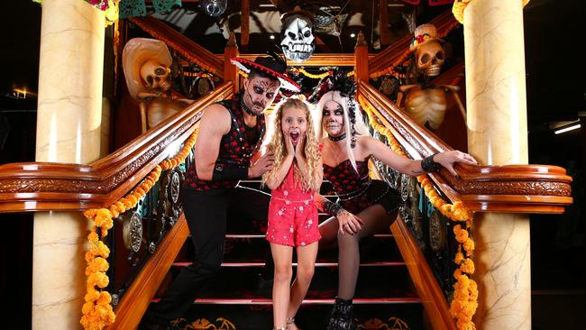 Billie Frampton 8 gets into the mood for Halloween and meets Matt Cook and Samantha Mills who are Draculettes from Draculas on the Gold Coast. Picture: Adam Head