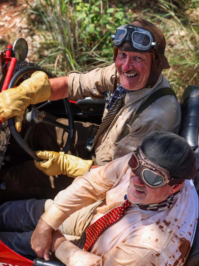 Our intrepid travellers sporting some fetching red mud. Picture: Nigel Wright