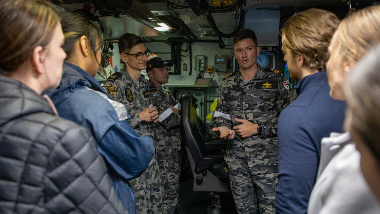 Clearance Diving Officer Lieutenant Benjamin Morgan speaks with Defence Force Recruiting candidates during a tour on-board HMAS Gascoyne earlier this year. Picture: LSIS Leo Baumgartner