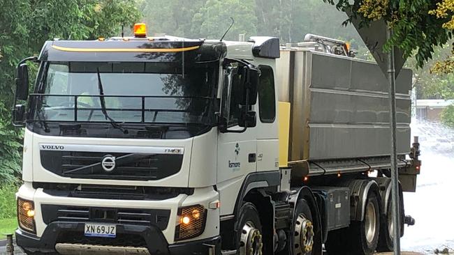 A council truck sprays water along sanded sections of Industry Drive and Cynthia Wilson Drive, East Lismore, which were two of the road closed after multiple oil spills on Wednesday March 17, 2021. Photo: Alison Paterson