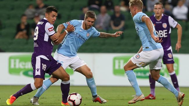 Perth’s Chris Ikonomidis takes on the Melbourne City defence on Saturday night