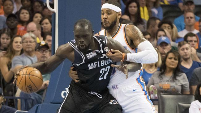 Majok Majok #22 of Melbourne United and Carmelo Anthony #7 of the Oklahoma City Thunder battle for the ball during a NBA preseason game on October 8, 2017.