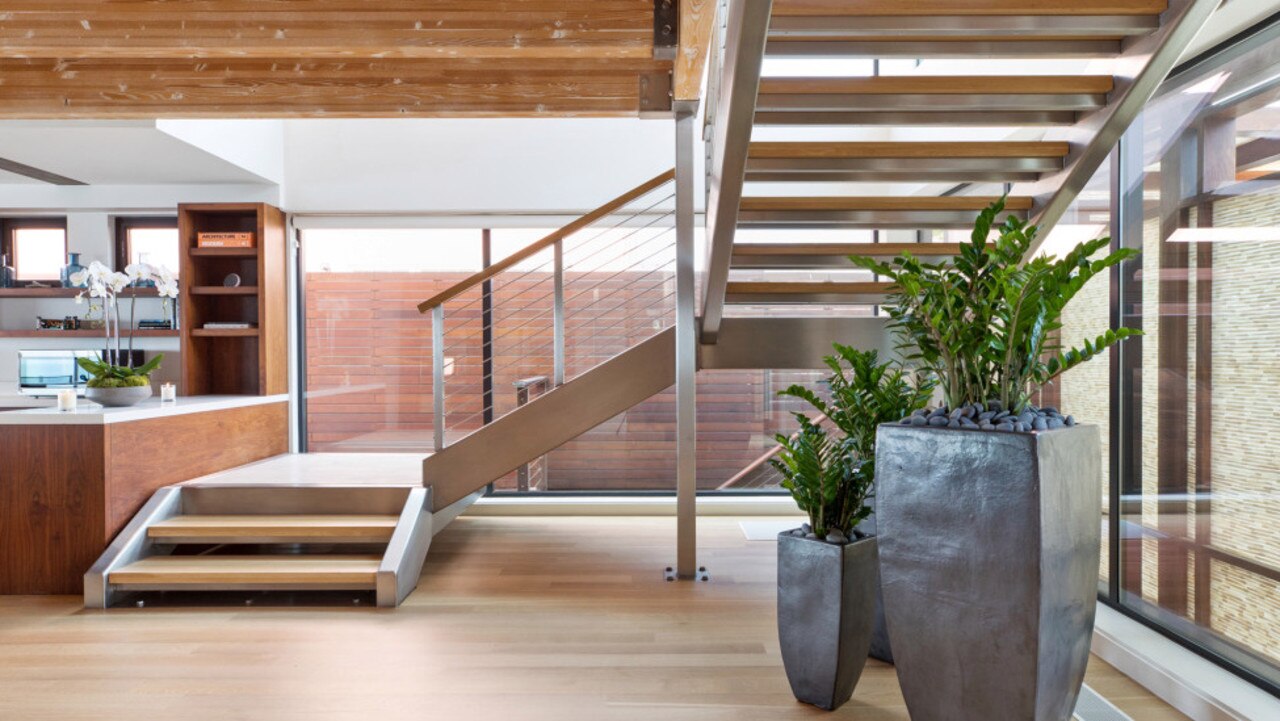 A steel-and-wood floating staircase connects the two stories. Picture: Realtor