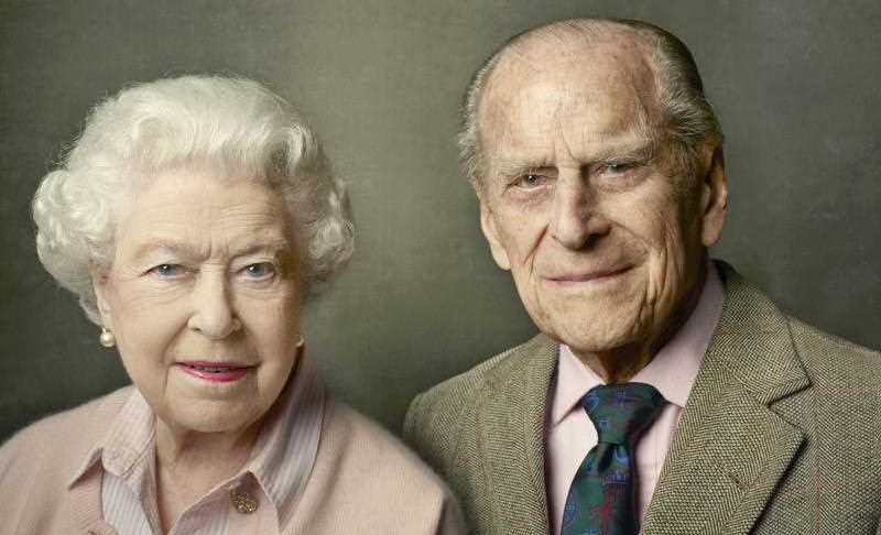 In this undated photo released by Buckingham Palace on Friday, June 10, 2016, Britain's Queen Elizabeth II, left and Prince Philip, the Duke of Edinburgh pose for a photograph to mark the Queen's 90th birthday, in Windsor, England. 