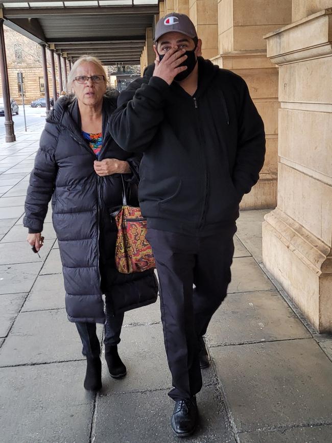 Haydn John Sansbury leaves the Supreme Court with a supporter.