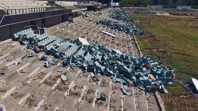 The slaughtered stadium seats seen piled up on the edges of what left of Pirtek Stadium.