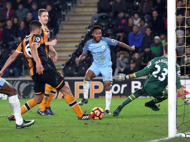 Manchester City's Raheem Sterling (C) sparks an own goal from Hull's Curtis Davies (L).