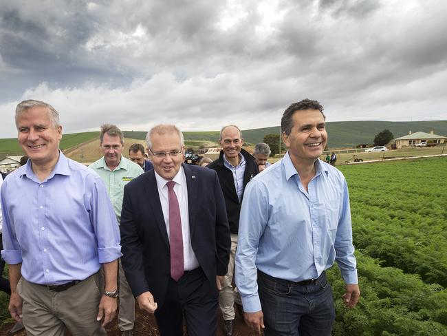 Nationals Leader Michael McCormack, Prime Minister Scott Morrison and Premium Fresh Managing Director Jim Ertler in a field of carrots in Braddon at Forth, Tasmania. Picture: CHRIS KIDD