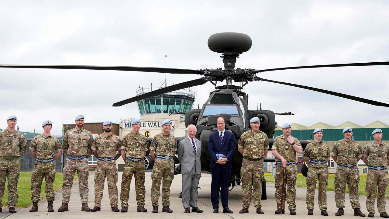 King Charles officially hands over the role of Colonel-in-Chief of the Army Air Corps to Prince William in front of an Apache helicopter at the Army Aviation Centre in Middle Wallop, England. Picture: AFP