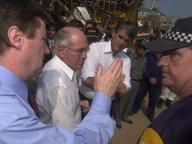 Escorting Prime Minister John Howard about the Sari Club bomb blast site in Kuta with AFP Commissioner Mick Keelty days after the attack.