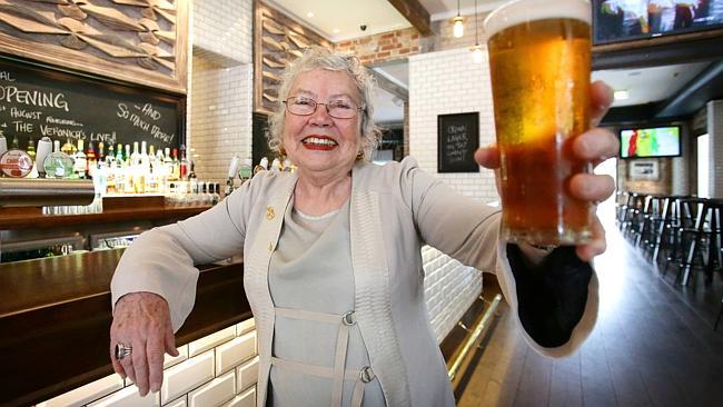 Merle Thornton enjoys a beer in the front bar of the Regatta Hotel.