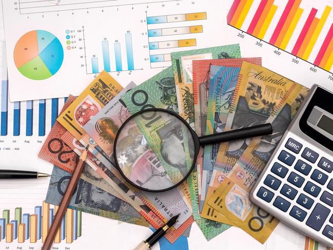 Business graphs with australian dollars, magnifier, pen and calculator Australian money tax generic