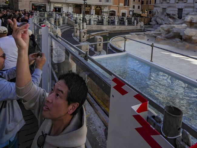 A small pool is seen in front of the Trevi Fountain to allow tourists to throw their coins in it, as the fountain has been emptied to undergo maintenance work that will last until around September 2025, in Rome, Friday, Nov. 1, 2024. (AP Photo/Andrew Medichini)