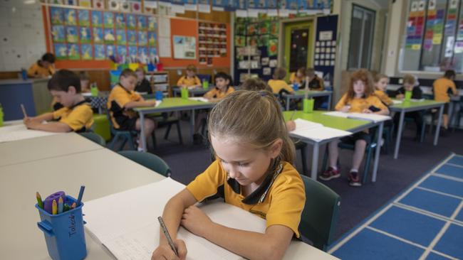 Taleah Harrison works in the classroom at her first day back at Gulmarrad Public School. Photo: Adam Hourigan