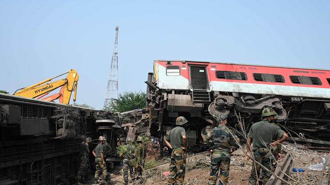 Military personnel search for survivors amid wreckage at the accident site. Picture: AFP