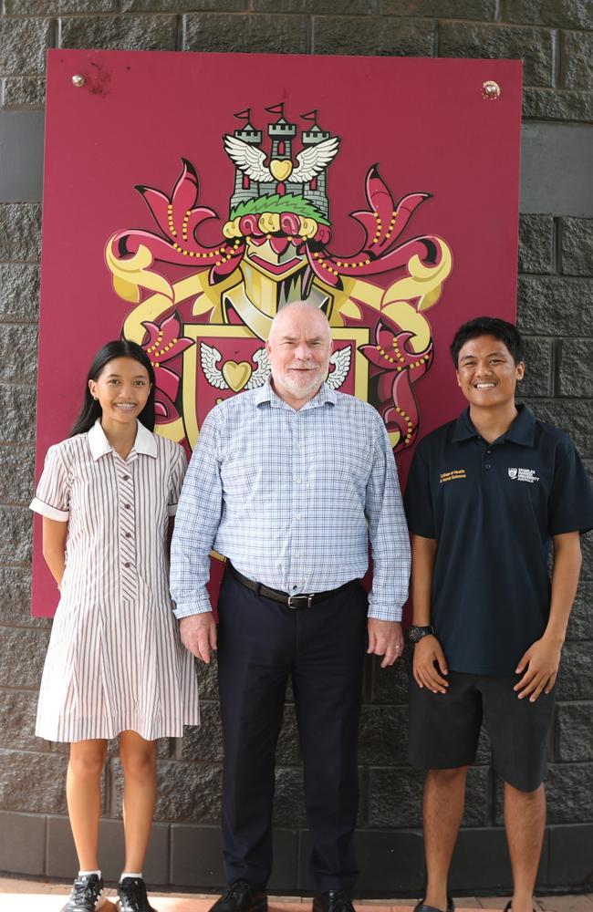 Eva and Peter Susanto with their principal Andrew McGregor. Picture: Darcy Fitzgerald