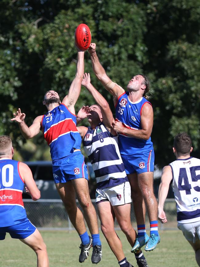 Jackson Williams, Kye Chapple and Jack Taylor contest a mark in the AFL Cairns seniors match between Centrals Trinity Beach Bulldogs and Port Douglas Crocs, held at Crathern Park, Trinity Beach. Picture: Brendan Radke