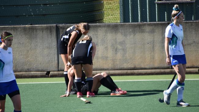 A Parkes player gets injured mid-match against Metro South West. at the NSW U-18's girls hockey championships.