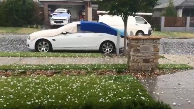 Hail batters a car at Oran Park late yesterday. Picture: EmmaSmidt/Twitter