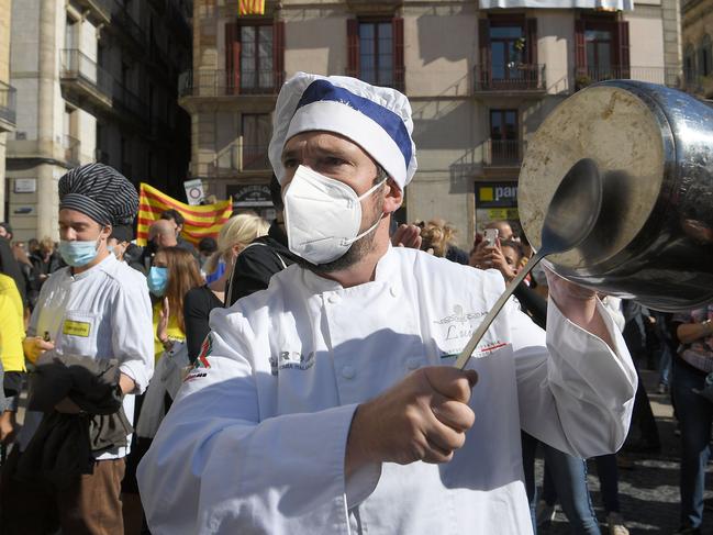 A cook bangs a pot during a demonstration in Barcelona to protest against the new restrictions imposed by the regional government on bars and restaurants. Picture: AFP