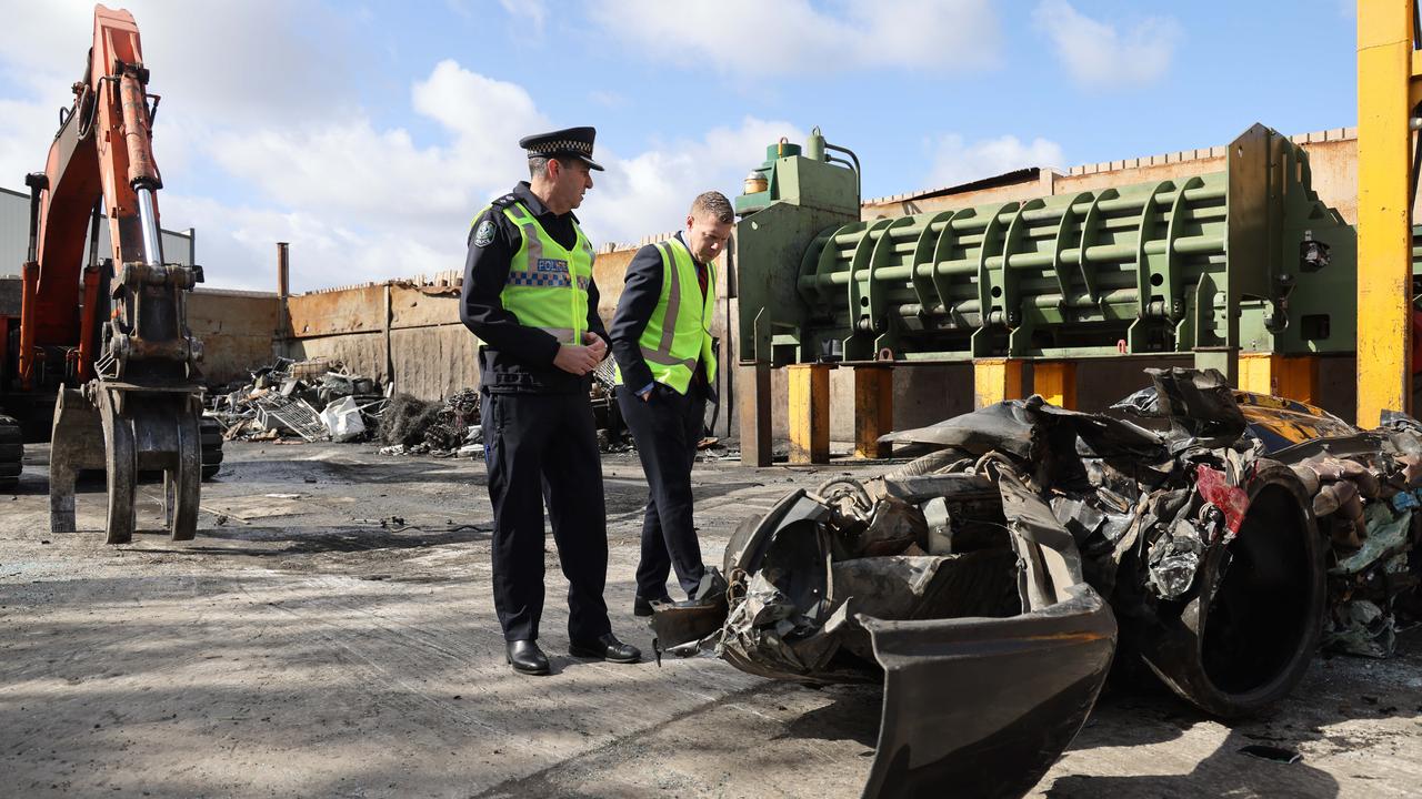 Former Minister for Police Joe Szakacs and Police Superintendent Darren Fielke display a Holden Commodore they had destroyed as punishment for its driver. Picture: NCA NewsWire / David Mariuz