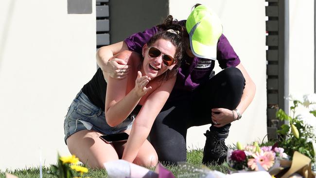 A mourner at the scene of the car fire to pay respects to Hannah Clarke and her three children. Picture: Liam Kidston