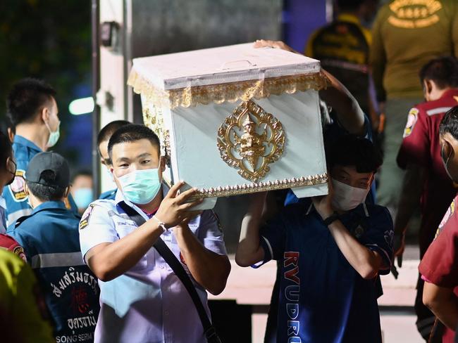 Rescue personnel carry a victim’s coffin at the hospital morgue in Udon Thani. Picture: AFP