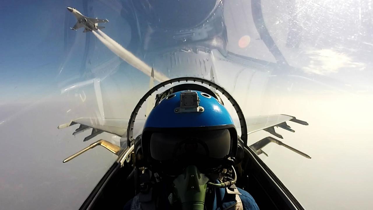 TOPSHOT - This undated photo shows two Chinese jet fighters during a military drill in the South China Sea near China's Hainan Island. An area off the east coast of China's island province of Hainan hosted military exercises from July 19 to 21. / AFP PHOTO / STR / China OUT