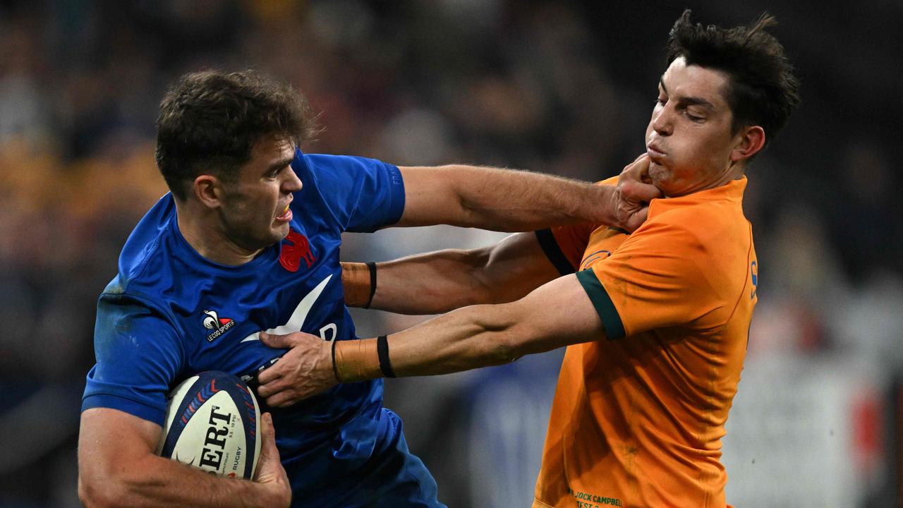 France's wing Damian Penaud runs with the ball past Australia's fullback Jock Campbell. (Photo by MARTIN BUREAU / AFP)