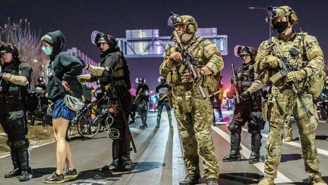 Minneapolis State Patrol arrest journalists and people protesting against racism and issues with the presidential election after they blocked interstate 94 in Minneapolis, Minnesota on Thursday. Picture: AFP