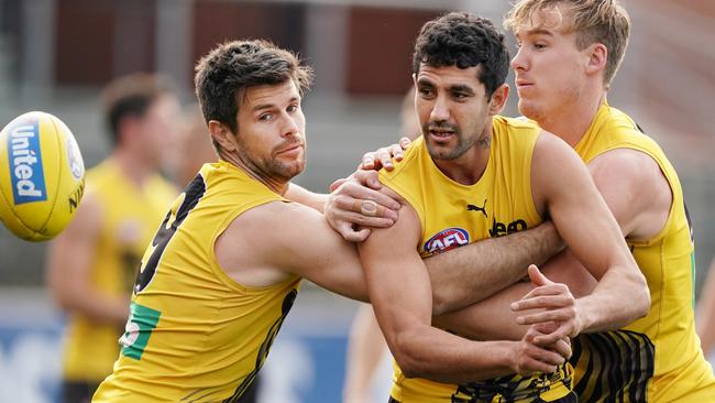 Trent Cotchin of the Tigers and Tom Lynch of the Tigers tackles Marlion Pickett of the Tigers during an AFL Richmond Tigers training session at Swinburne Centre in Melbourne, Tuesday, June 16, 2020. (AAP Image/Michael Dodge) NO ARCHIVING