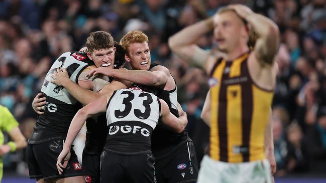 ADELAIDE, AUSTRALIA - SEPTEMBER 13: Jordon Sweet, Mitch Georgiades, Darcy Byrne-Jones and Willem Drew of the Power celebrate their win during the 2024 AFL Second Semi Final match between the Port Adelaide Power and the Hawthorn Hawks at Adelaide Oval on September 13, 2024 in Adelaide, Australia. (Photo by James Elsby/AFL Photos via Getty Images)