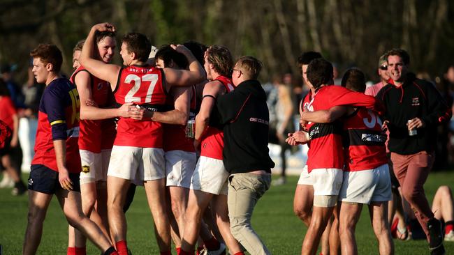 Romsey players embrace after the final siren. Picture: Mark Dadswell