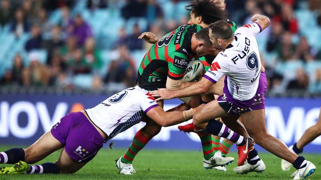 Cameron Smith (right) is bumped away as he attempts to tackle Sam Burgess of the Rabbitohs at ANZ Stadium. Picture: Getty Images