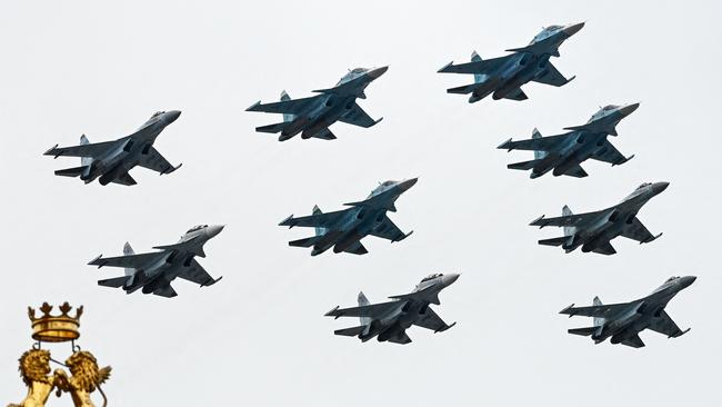 Russian Sukhoi Su-35S fighter aircrafts, Su-34 military fighter jets and Su-30SM jet fighters fly in formation over central Moscow. Picture: AFP