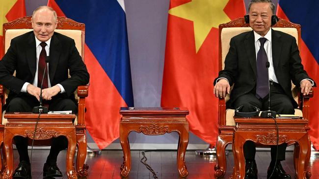 Russia's President Vladimir Putin (L) and Vietnam's President To Lam (R) take part in an event attended by the Vietnam Friendship Association and generations of Vietnamese alumni that studied in Russia at the Hanoi Opera House in Hanoi on June 20, 2024. (Photo by Manan VATSYAYANA / POOL / AFP)