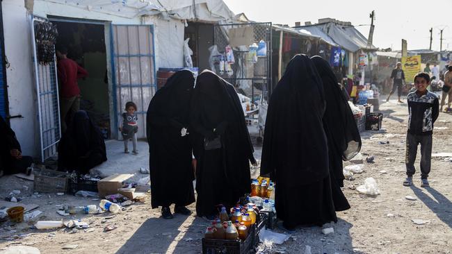 Women buying food at the Al Hawl camp in Syria. Picture: AAP Image/Tessa Fox