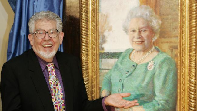 Rolf Harris with his portrait of Queen Elizabeth II. Picture: AP