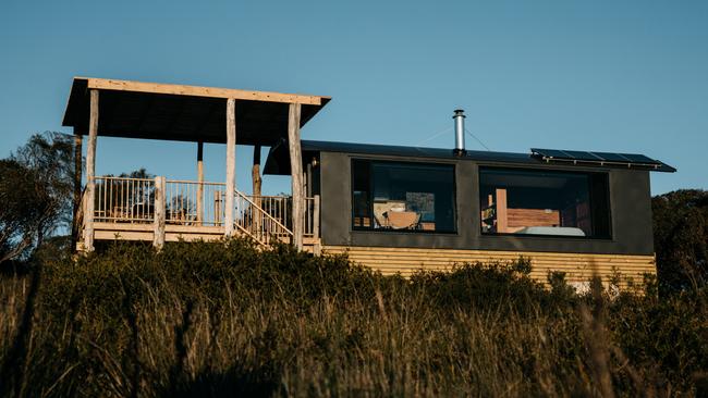 Tara and Luke Rowe spent two years refurbishing the early 1900s train carriage into a cosy, coastal accommodation. Picture: Robert Lang