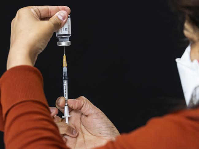 MELBOURNE, AUSTRALIA - NewsWire Photos October 15, 2021:  Health staff prepare syringes with doses of the Moderna vaccination inside the pharmacy at a pop-up COVID vaccination hub at Casey Fields in Cranbourne, Melbourne, Victoria. Picture: NCA NewsWire / Daniel Pockett