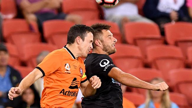 Brisbane Roar captain Matt McKay (left) and Newcastle’s Kaine Sheppard compete for the ball on Saturday night. Picture: Getty Images 