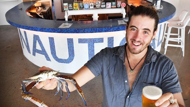 The Nautical manager Cody Smith shows off a crab and an ale. Picture: Patrick Woods.