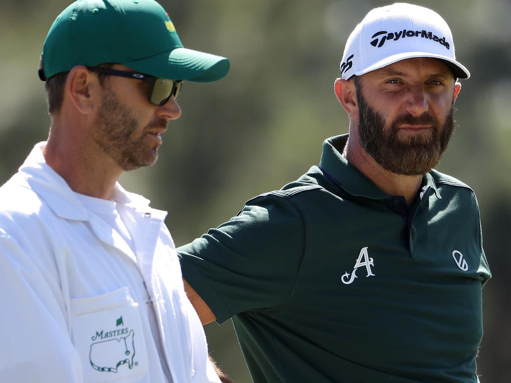 Dustin Johnson looks on from the 17th green with his caddie during round two. Picture: Jamie Squire/Getty Images