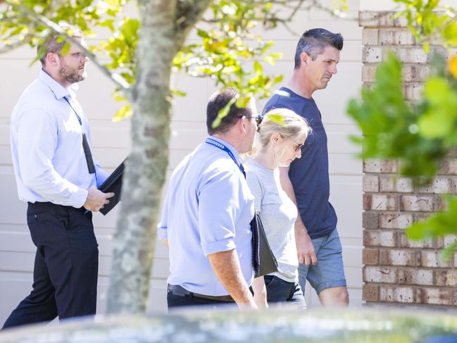 Lee Lovell with detectives at his house on Tuesday. Picture: Richard Walker