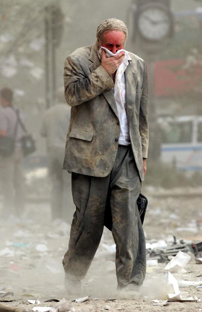 Edward Fine covering his mouth as he walks through the debris following the collapse of one of the twin towers. Picture: AFP Photo / Stan Honda