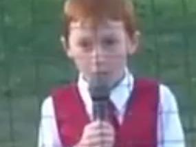 Ethan Hall, 7, battles through hiccups during his performance of the Australian National Anthem at a Baseball game in Norwood. Screengrab from video posted on YouTube by ABLtv.com