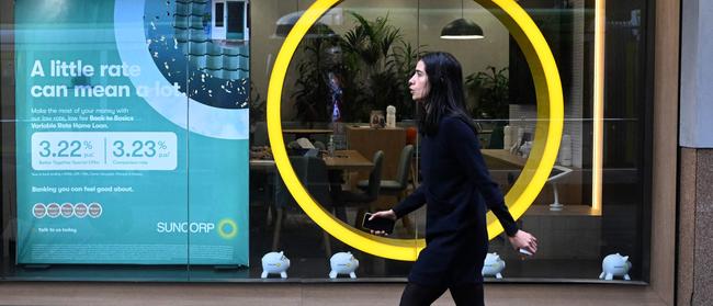 A pedestrian walks past a Suncorp Bank branch in Melbourne.