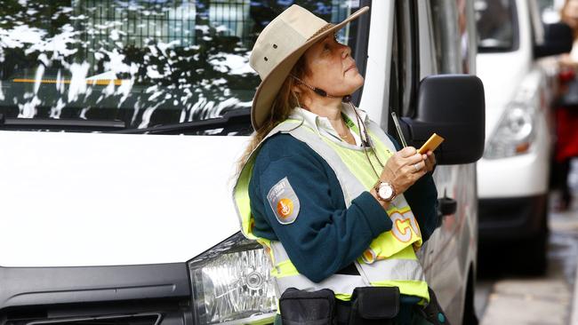 A City of Sydney parking ranger in action in the CBD. Picture: John Appleyard