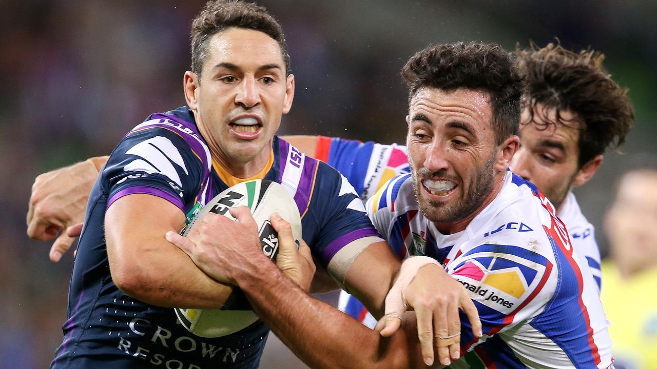 Billy Slater is tackled by Brock Lamb.